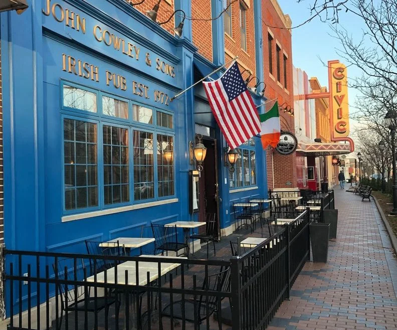 The blue John Cowley and Sons storefront on Grand River Avenue